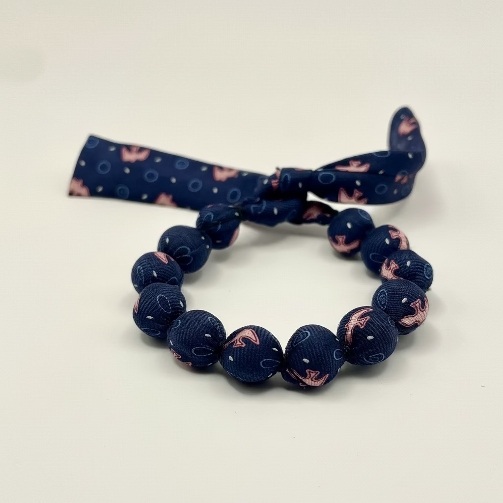 Bracelet perles de soie bleu marine et rose motif hirondelles